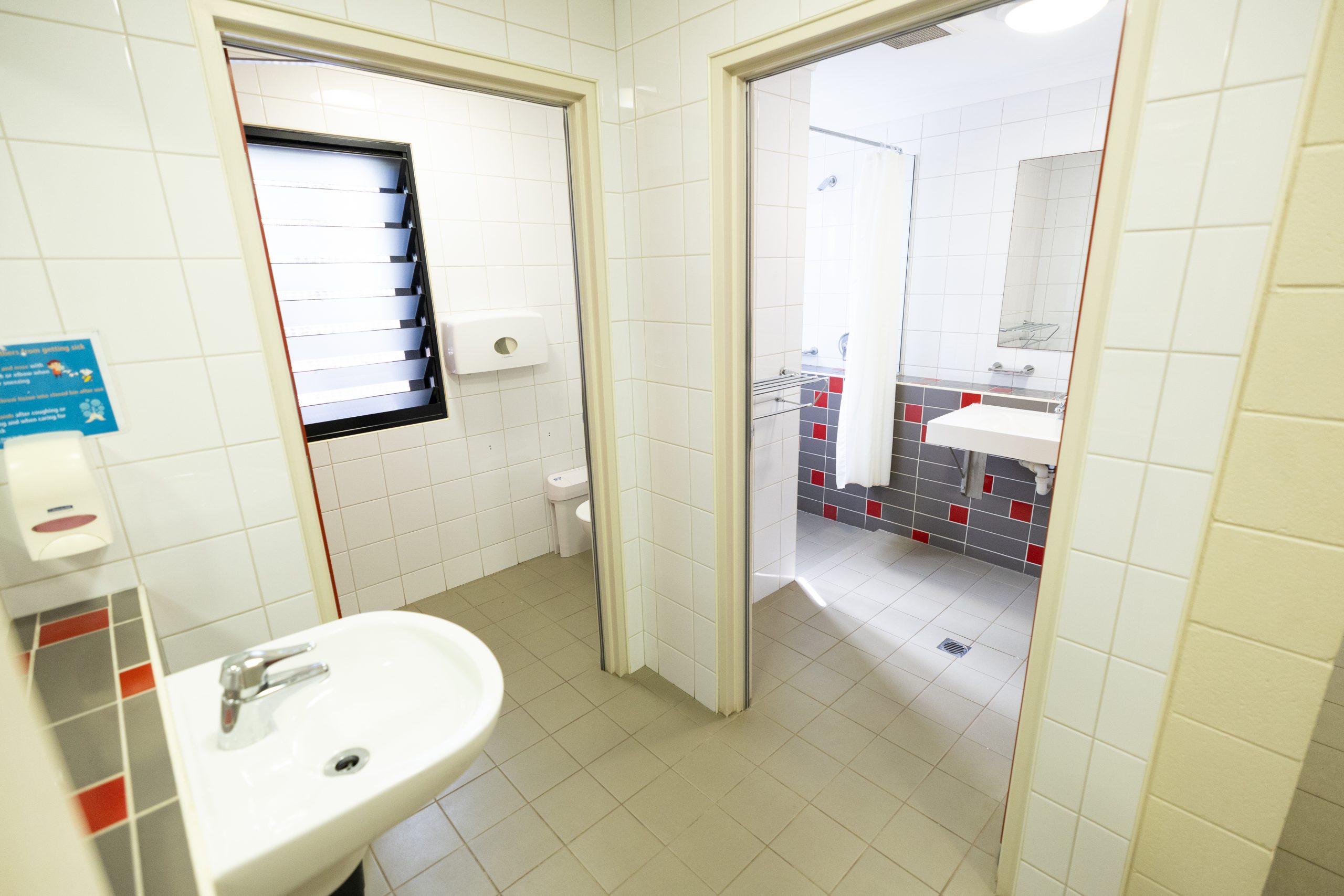 Bathroom in a different angle, showing toilet, shower, sink