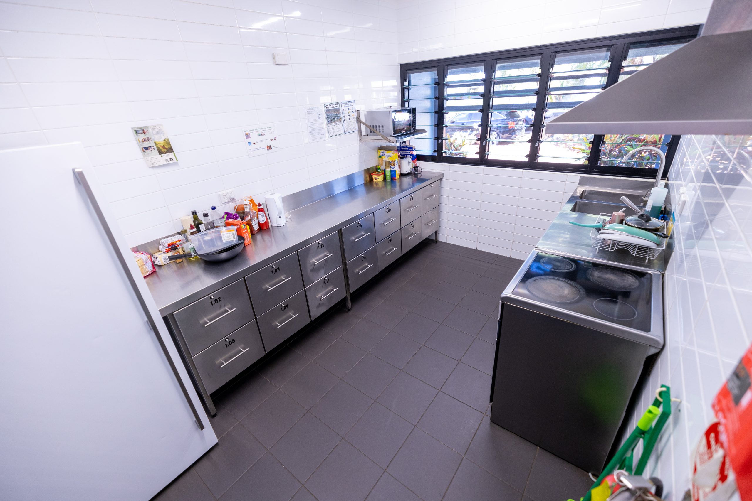 Shared kitchen with stove, preparation bench, fridge.